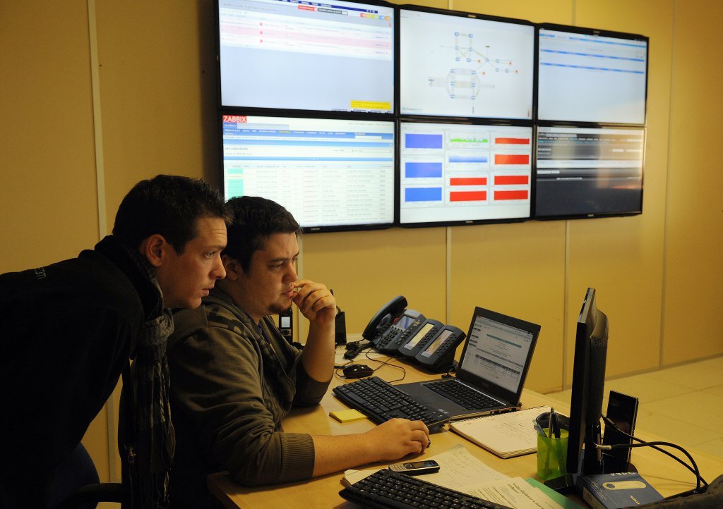 Employees analyzing the data on their computer screens. Source: AFP